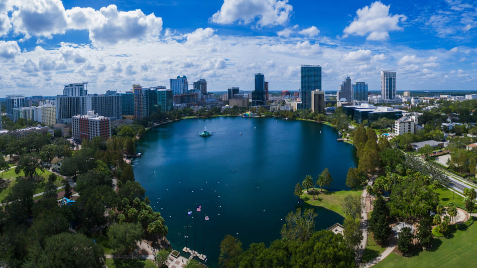 A view of Lake Eola and its surroundings in Orlando Florida on a beautiful sunny day